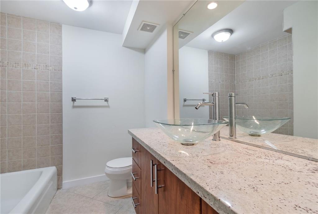 950 Ponce De Leon Road, Unit 408 Boca Raton, FL 33432 - Photo 14 of 50 a bathroom with a granite countertop sink a toilet and bathtub