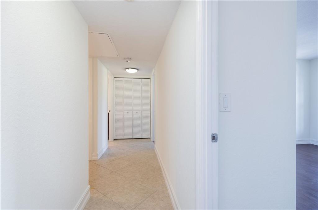 950 Ponce De Leon Road, Unit 408 Boca Raton, FL 33432 - Photo 19 of 50 a view of a hallway with closet and bathroom