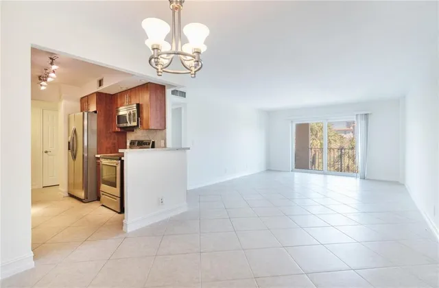 a kitchen with stainless steel appliances a stove a microwave and sink