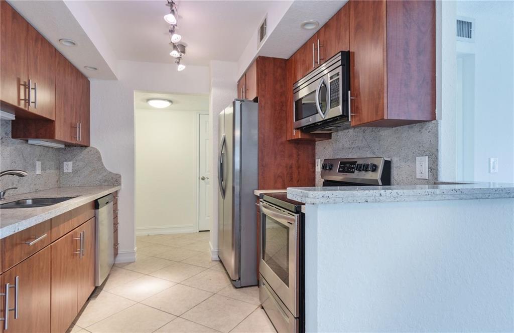 950 Ponce De Leon Road, Unit 408 Boca Raton, FL 33432 - Photo 7 of 50 a kitchen with stainless steel appliances granite countertop a refrigerator stove and sink