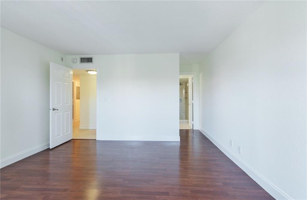 950 Ponce De Leon Road, Unit 408 Boca Raton, FL 33432 - Photo 9 of 50 a view of an empty room with wooden floor and closet