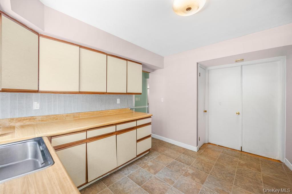4 Cooks Lane Westhampton, NY 11977 - Photo 22 of 33 Kitchen featuring cream cabinets, light countertops, and stone finish flooring