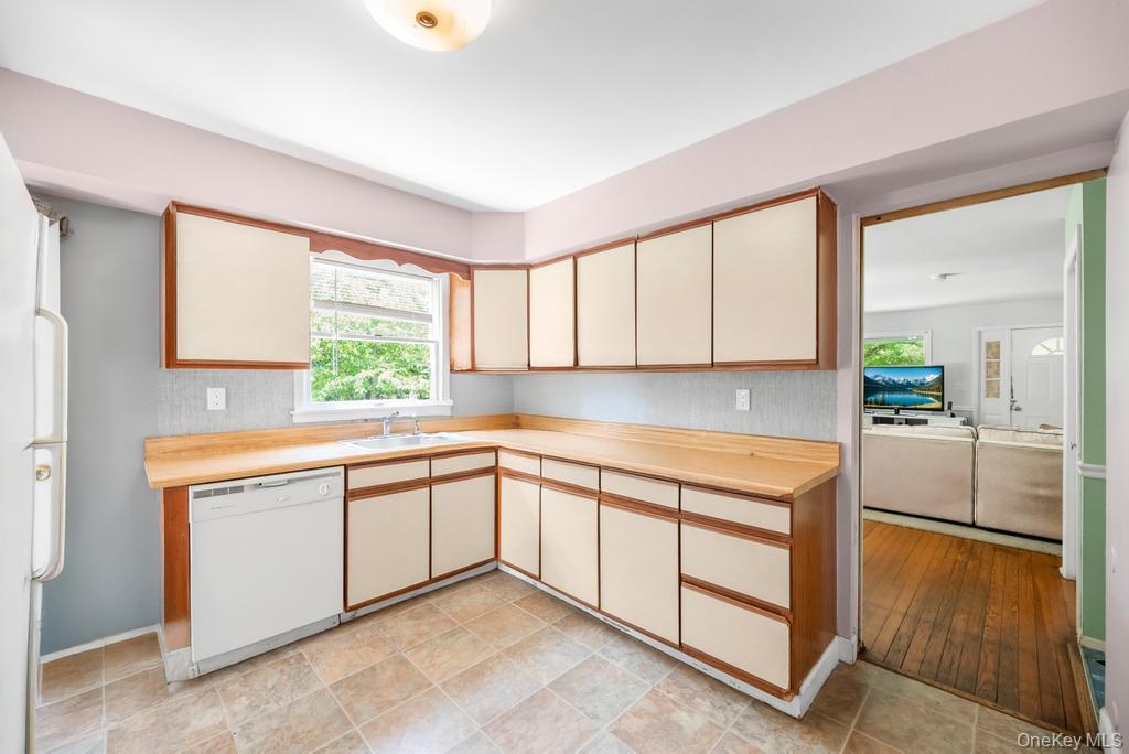 4 Cooks Lane Westhampton, NY 11977 - Photo 23 of 33 Kitchen featuring white appliances, light countertops, and cream cabinets