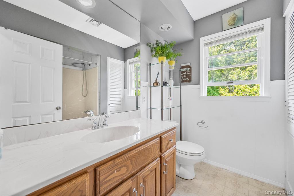 4 Cooks Lane Westhampton, NY 11977 - Photo 27 of 33 Bathroom featuring vanity, a shower, and healthy amount of natural light