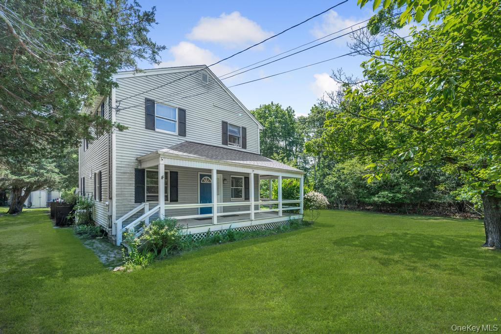 4 Cooks Lane Westhampton, NY 11977 - Photo 4 of 33 View of front facade featuring covered porch and a front yard