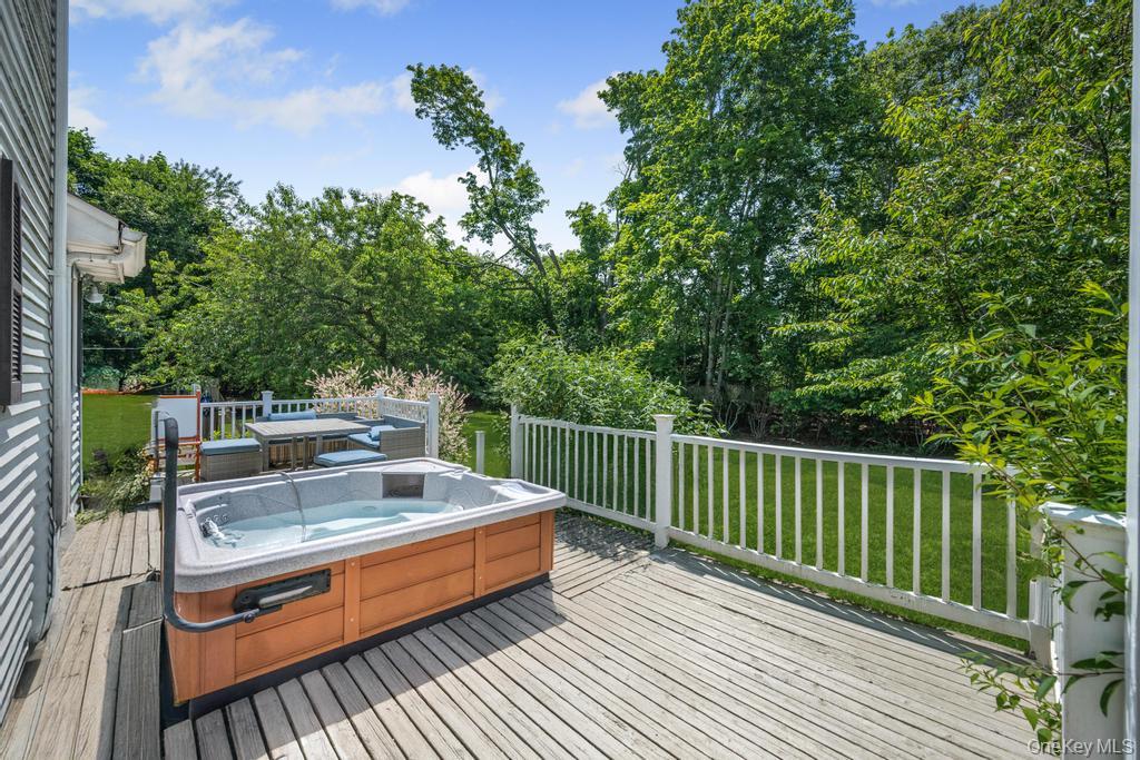 4 Cooks Lane Westhampton, NY 11977 - Photo 7 of 33 Deck with a hot tub and a yard