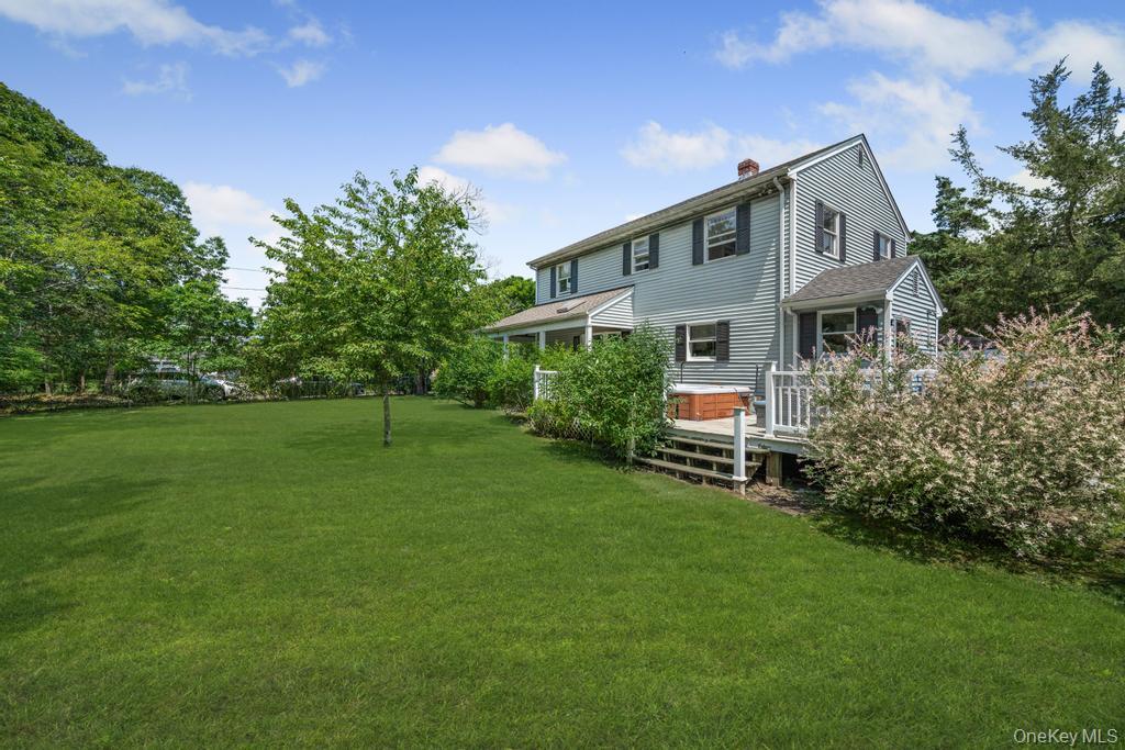 4 Cooks Lane Westhampton, NY 11977 - Photo 8 of 33 View of green lawn with a deck