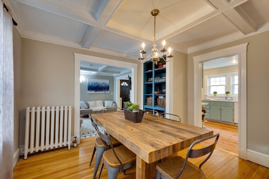 a view of a dining room with furniture wooden floor and chandelier