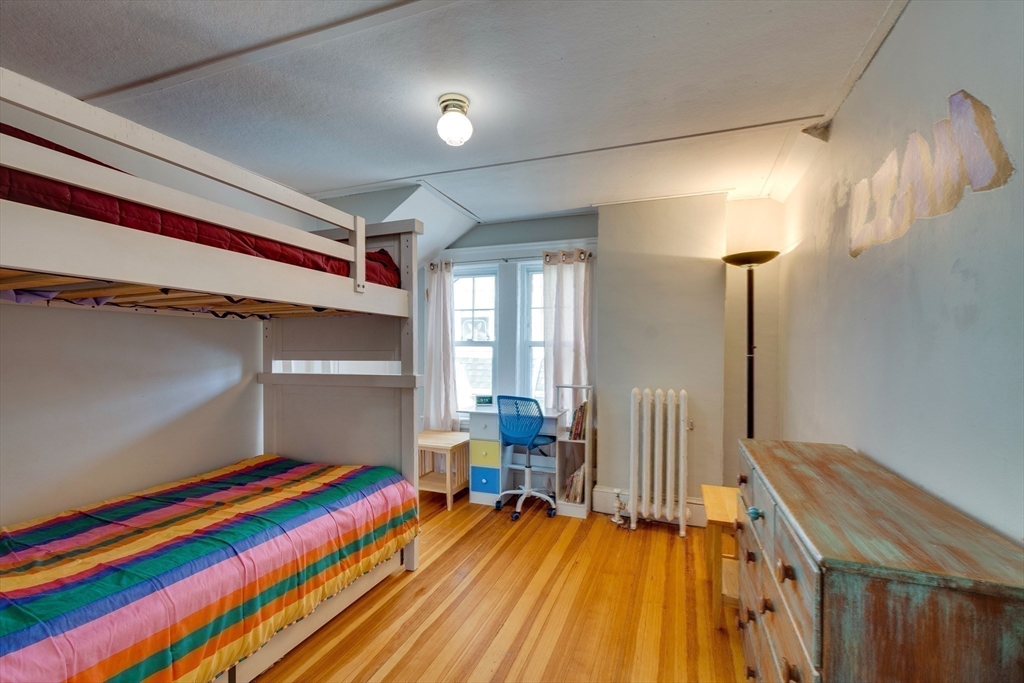 30 Kilsythe Road Arlington, MA 02476 - Photo 22 of 31 a room with a bed and a chandelier