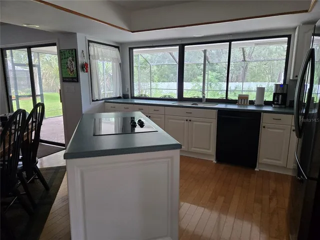 a kitchen with granite countertop a stove and a sink