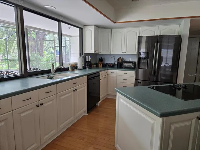 a kitchen with a sink stove and refrigerator