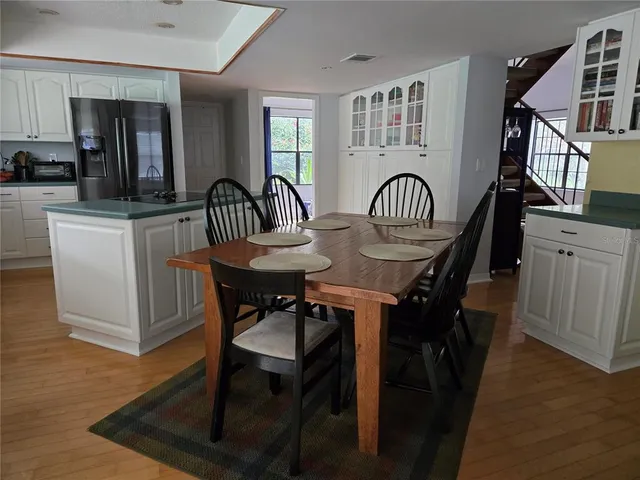 a view of a a dining room with furniture window and wooden floor