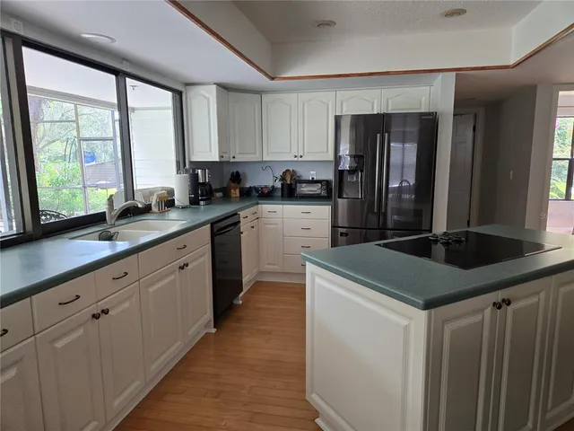 a kitchen with a sink stove and cabinets