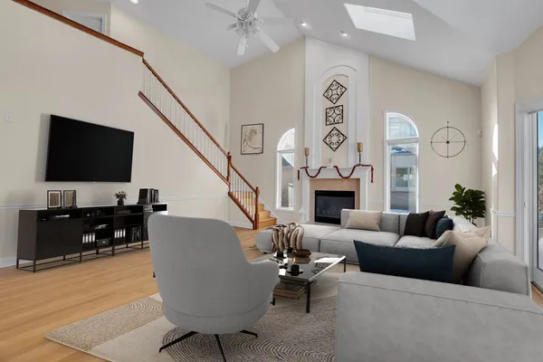 a living room with furniture a flat screen tv and a fireplace