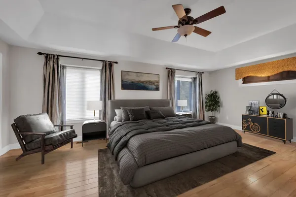 a bedroom with a bed a couch and a chandelier