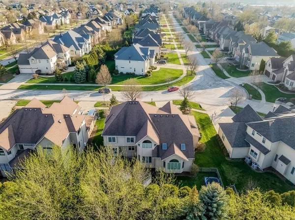an aerial view of residential houses with outdoor space and swimming pool