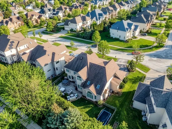 an aerial view of residential house with outdoor space and swimming pool