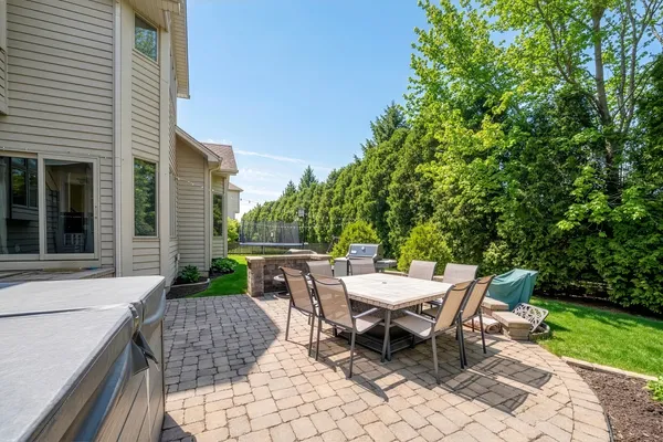a view of backyard with seating space and trees