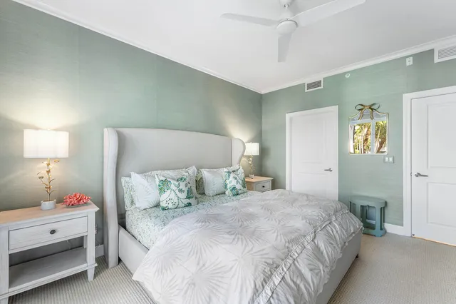 a bedroom with a white bed and a lamp