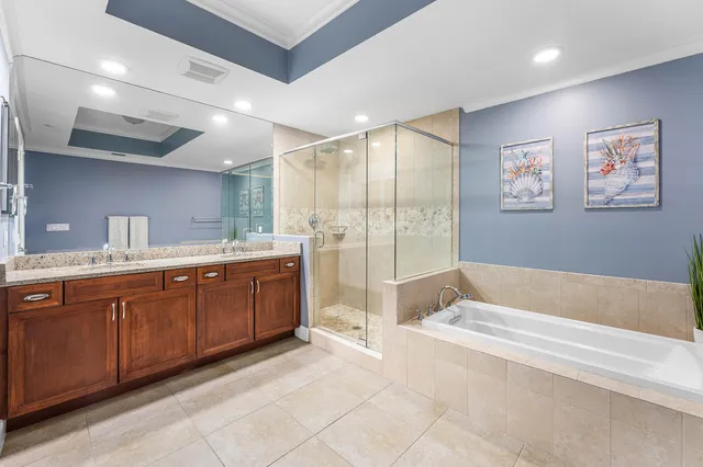 a spacious bathroom with a tub sink and mirror