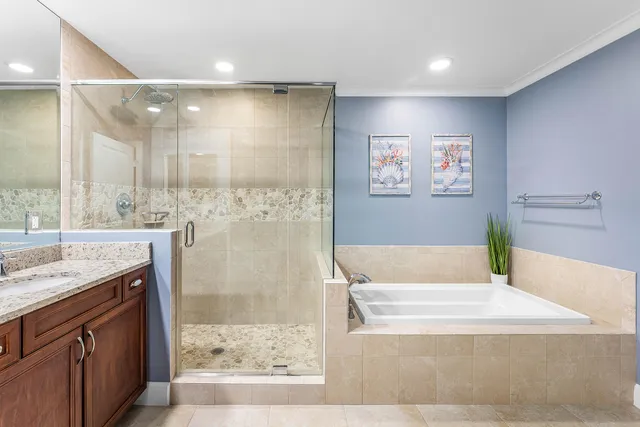 a bathroom with a tub a sink and a shower