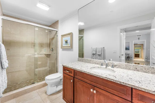 a bathroom with a granite countertop sink toilet and shower