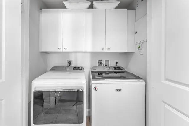 a kitchen with a stove and white cabinets