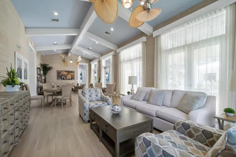 a living room with furniture a rug and a chandelier