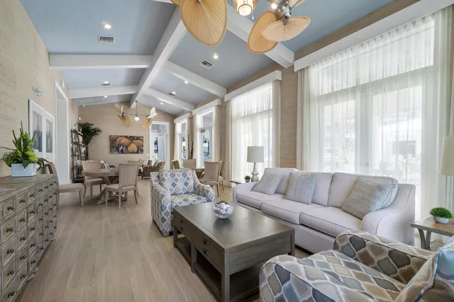 a living room with furniture a rug and a chandelier