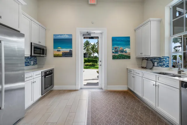 a front view of multiple house with yard and green space