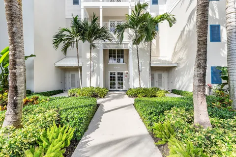 a view of a room with wooden floor windows and chandelier
