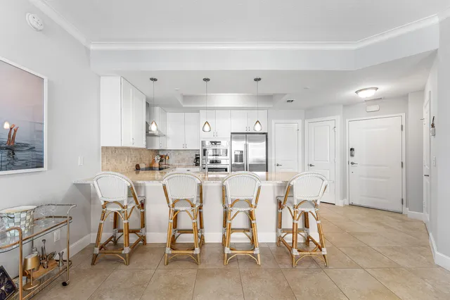 a large kitchen with a table and chairs