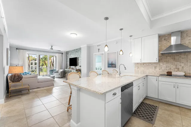 a open kitchen with stainless steel appliances granite countertop a sink dishwasher a stove and a refrigerator with wooden floor