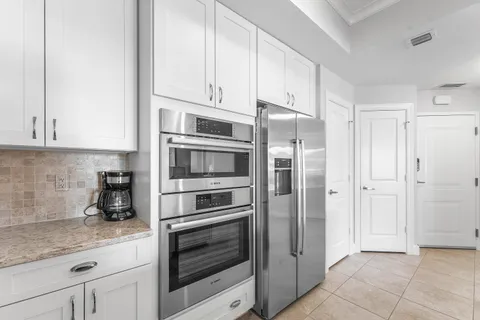 a kitchen with stainless steel appliances granite countertop a refrigerator and cabinets