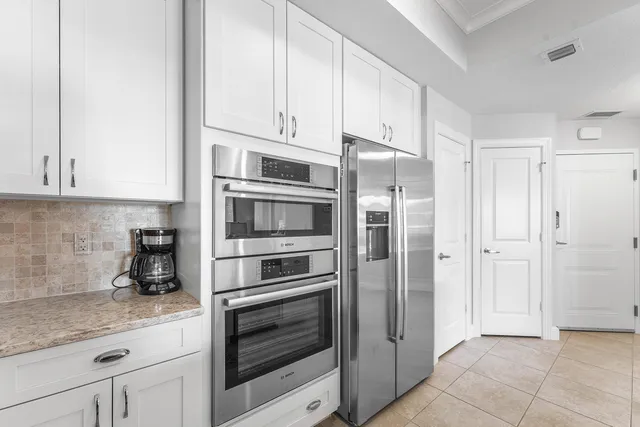 a kitchen with stainless steel appliances granite countertop a refrigerator and cabinets