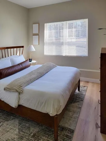 a bed sitting in a bedroom next to a window