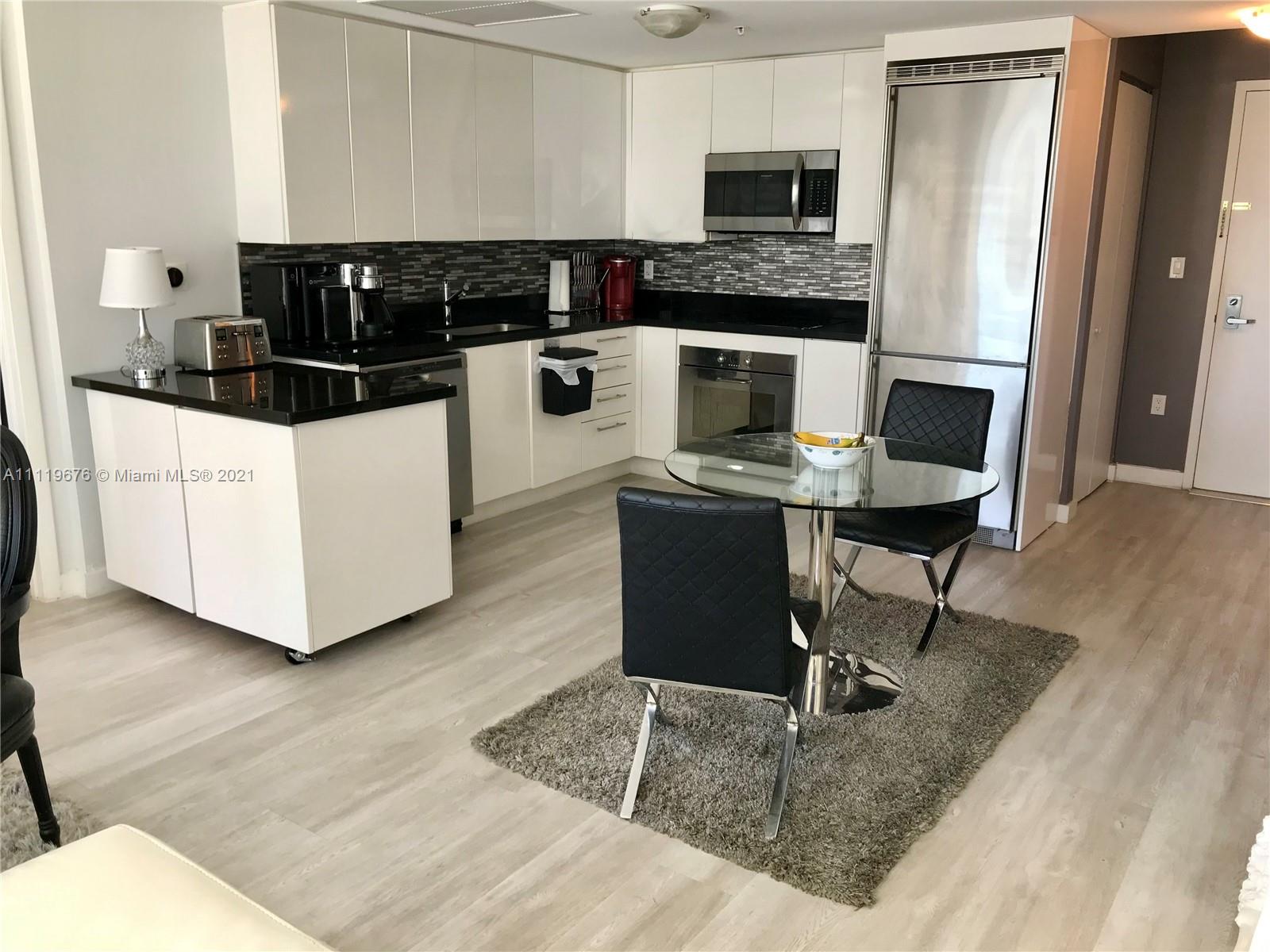 92 Southwest 3rd Street, Unit 1503 Miami, FL 33130 - Photo 2 of 14 a kitchen with a appliances and cabinets