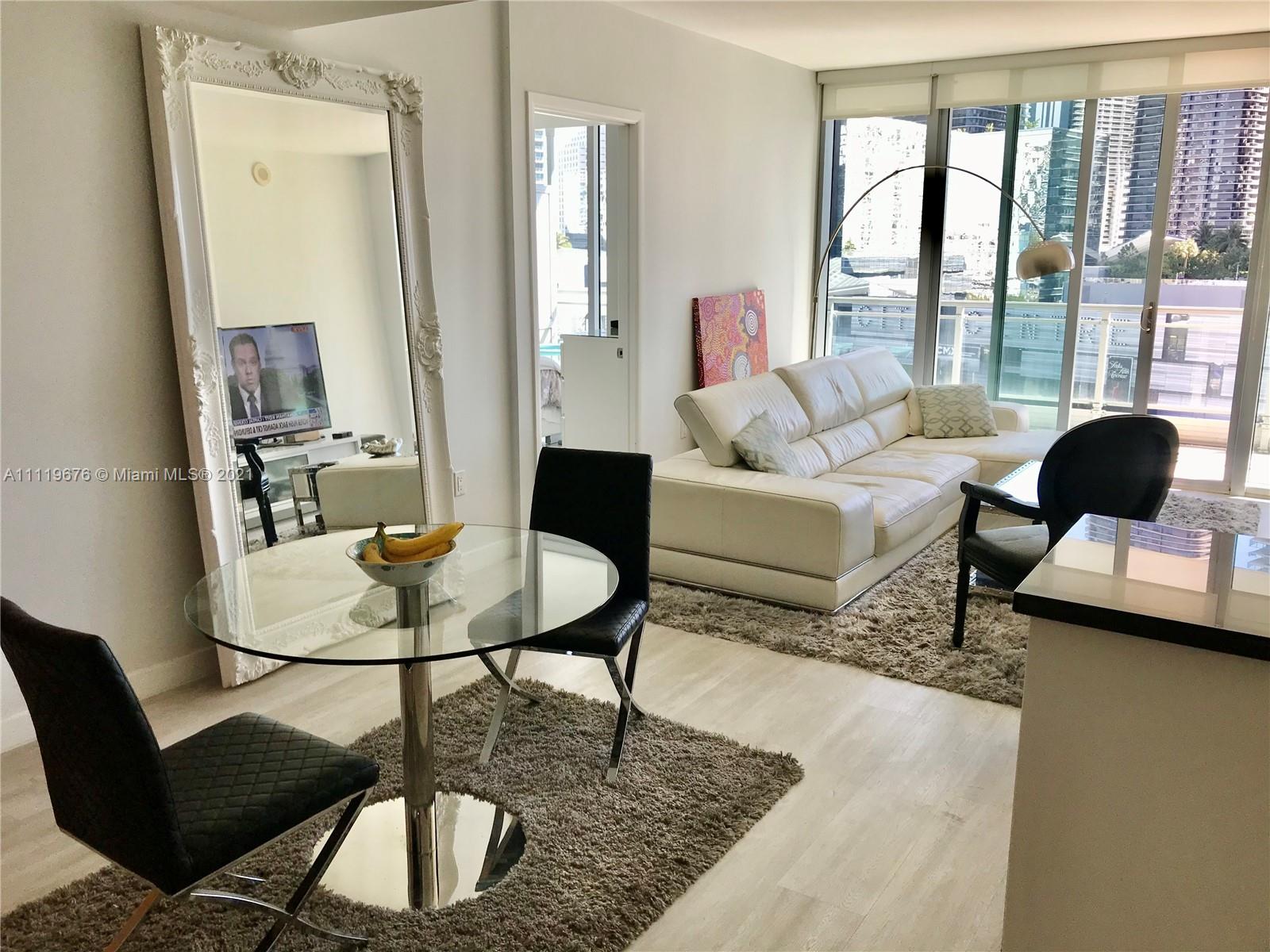 92 Southwest 3rd Street, Unit 1503 Miami, FL 33130 - Photo 3 of 14 a living room with furniture and large windows