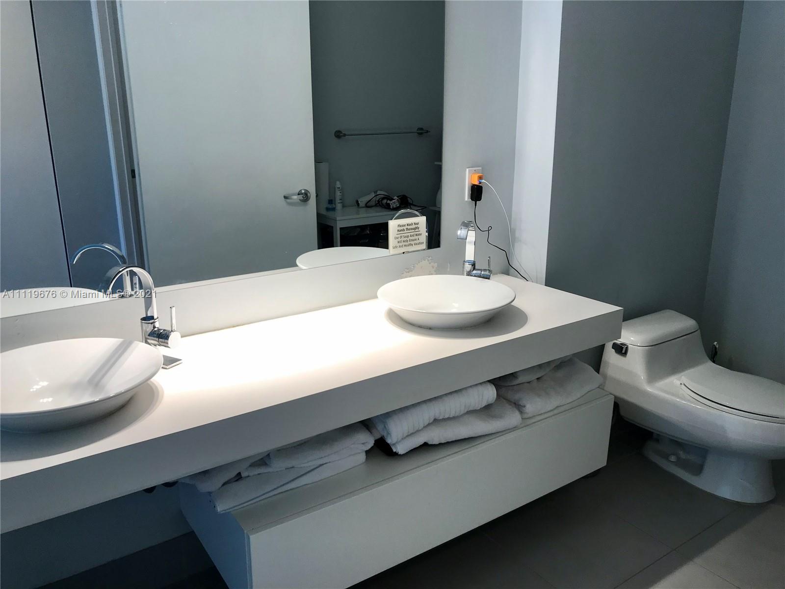 92 Southwest 3rd Street, Unit 1503 Miami, FL 33130 - Photo 6 of 14 a bathroom with a sink and a toilet