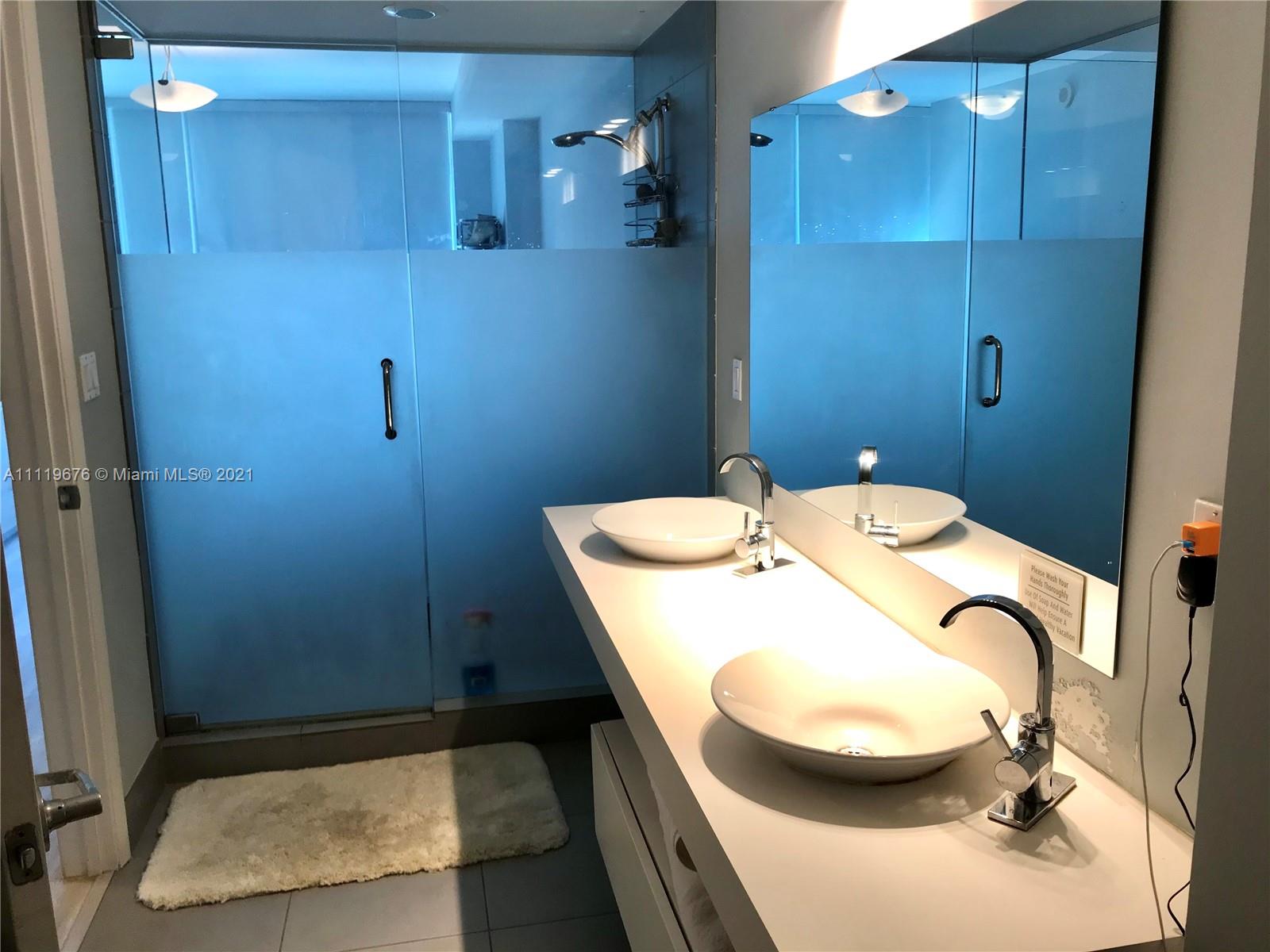 92 Southwest 3rd Street, Unit 1503 Miami, FL 33130 - Photo 7 of 14 a bathroom with a sink and mirror