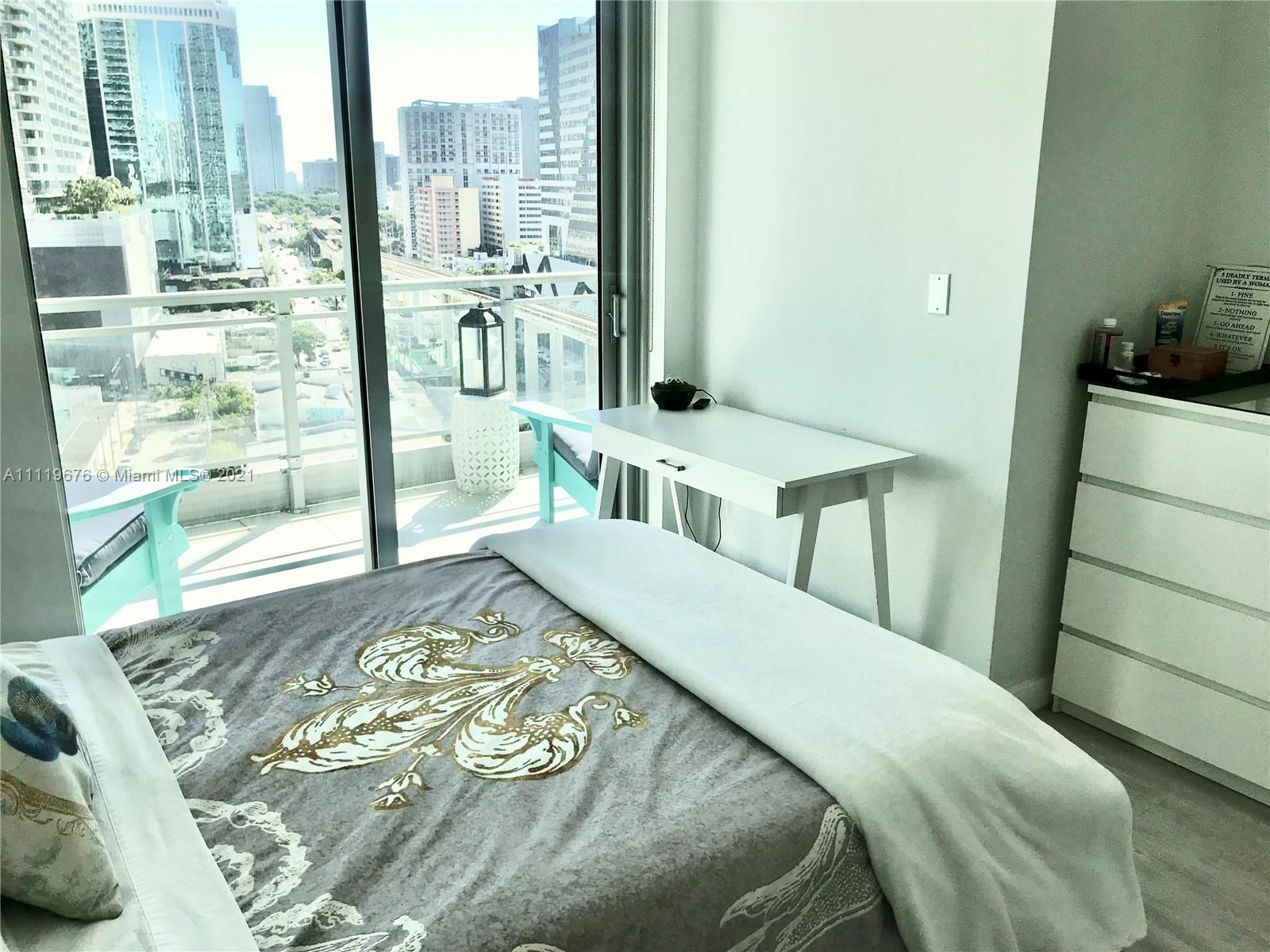 92 Southwest 3rd Street, Unit 1503 Miami, FL 33130 - Photo 9 of 14 a bedroom with a bed and a window