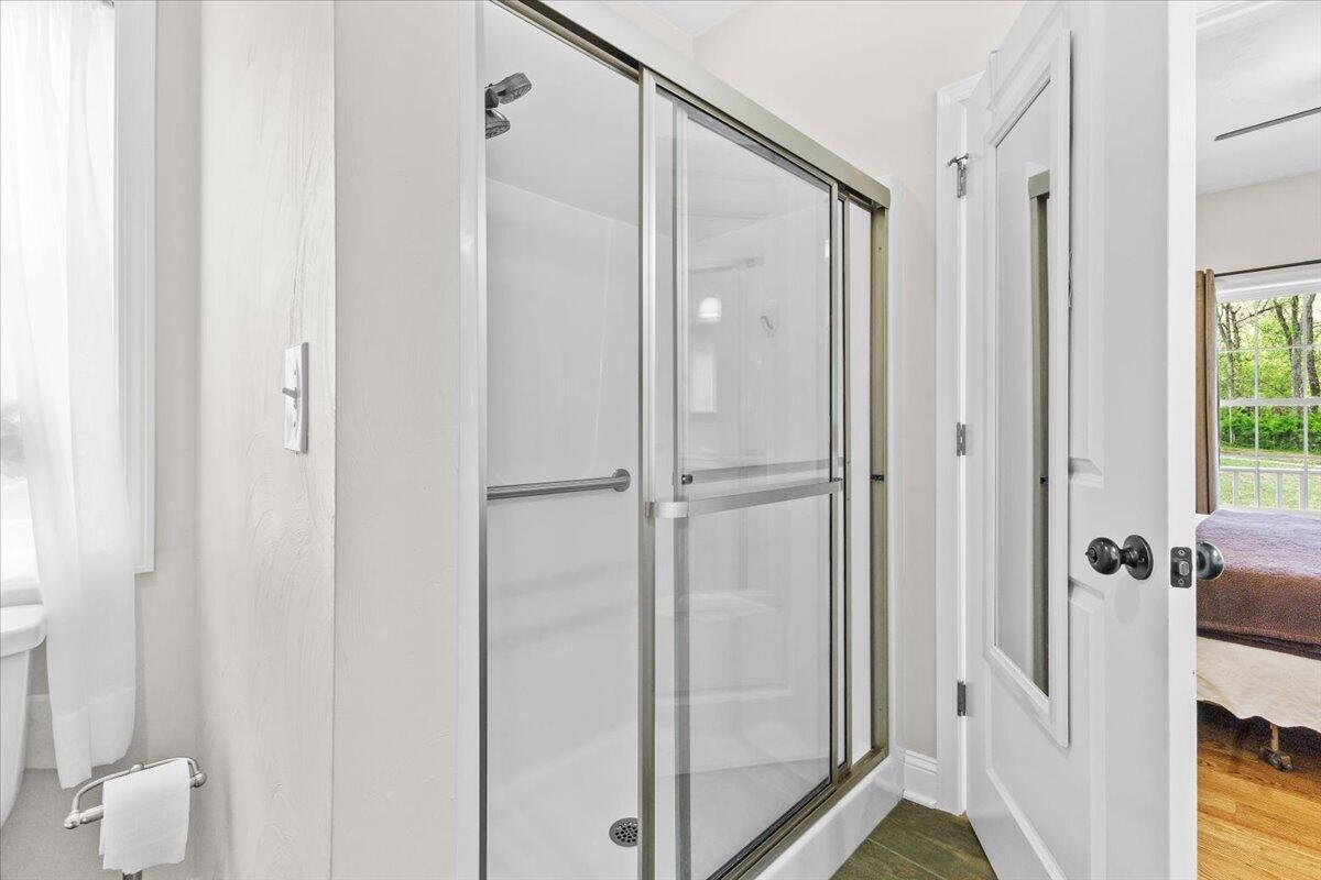 4133 Grove Hill Road Fincastle, VA 24090 - Photo 18 of 66 a bathroom with a shower and a glass door