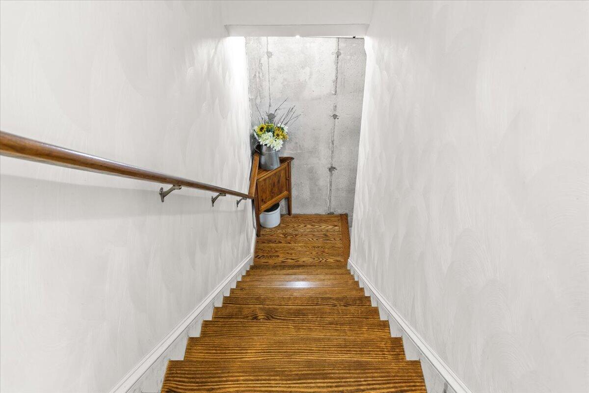 4133 Grove Hill Road Fincastle, VA 24090 - Photo 26 of 66 a view of a hallway with wooden floor and stairs