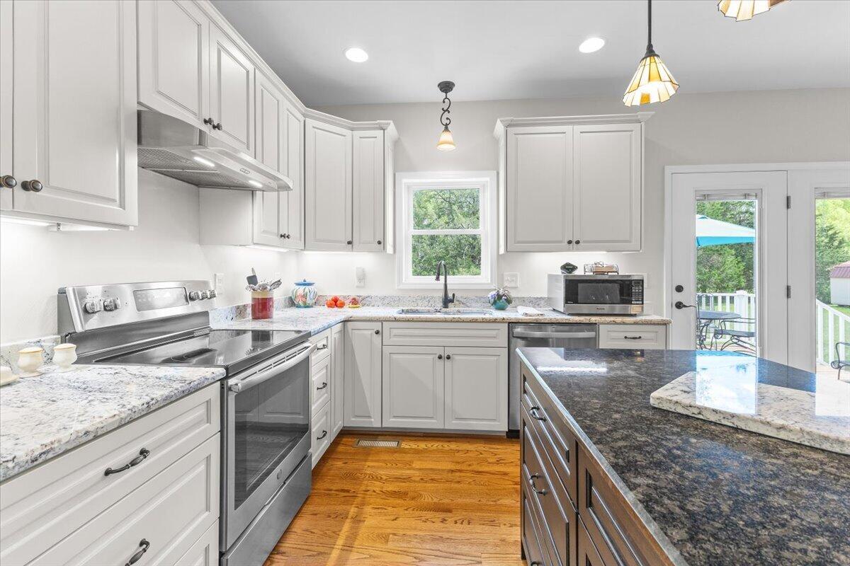 4133 Grove Hill Road Fincastle, VA 24090 - Photo 6 of 66 a kitchen with stainless steel appliances granite countertop a sink stove and cabinets