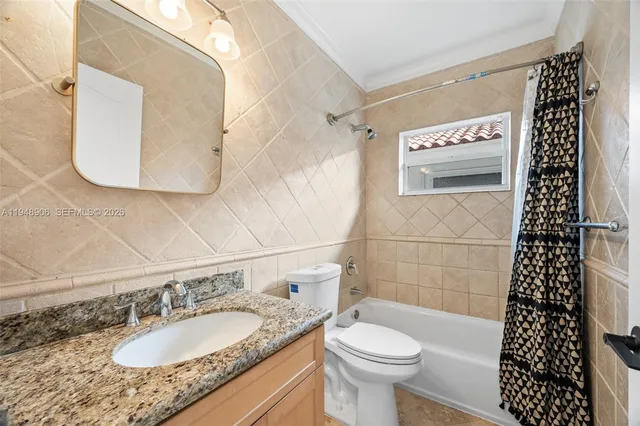 a bathroom with a granite countertop toilet a sink and a mirror