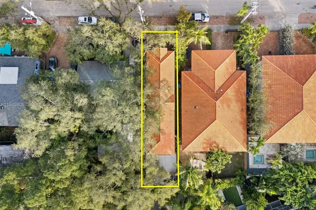 an aerial view of a residential houses with yard