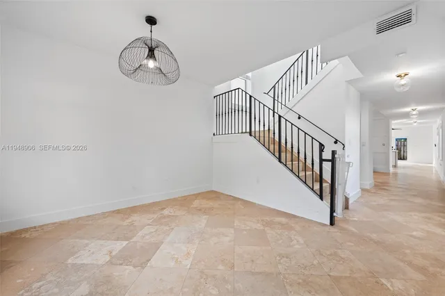 a view of a hallway with a chandelier