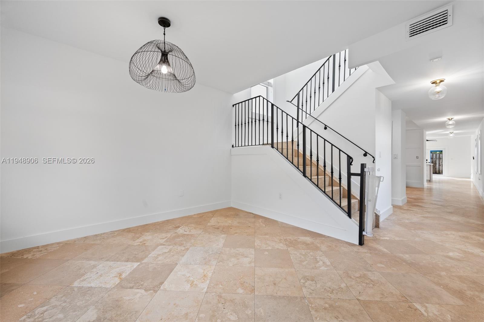2922 Virginia Street, Unit 2922 Miami, FL 33133 - Photo 4 of 23 a view of a hallway with a chandelier