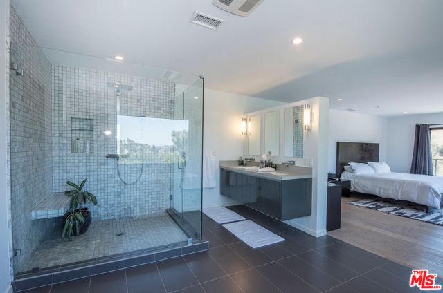 a large bathroom with a double vanity sink and mirror