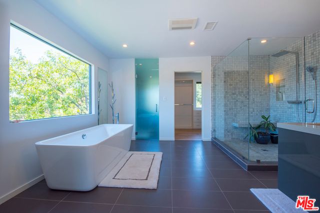 a view of an empty room and window with wooden floor